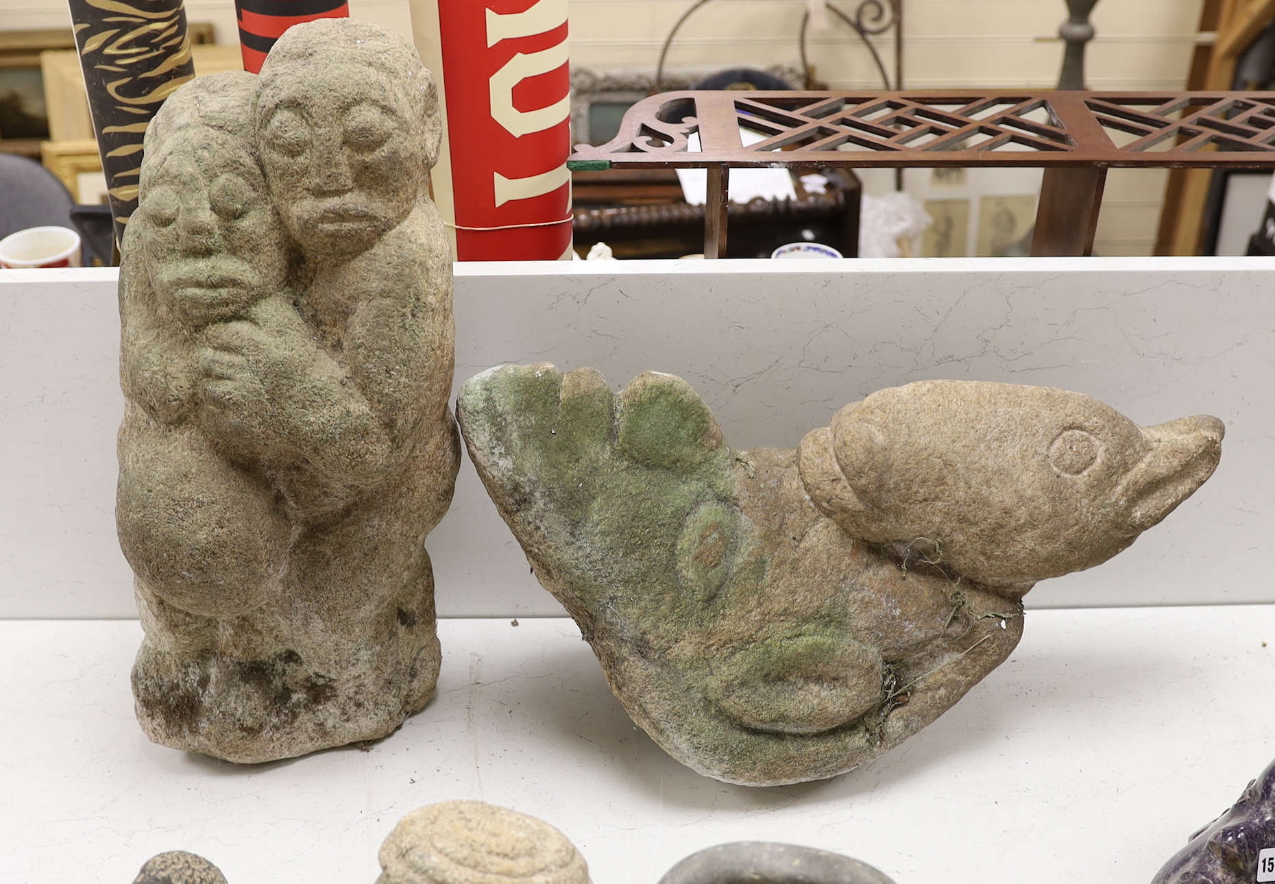Two large Shona weathered stone carvings, 1960s-70s; a group with pregnant woman and a bird, tallest 56cm